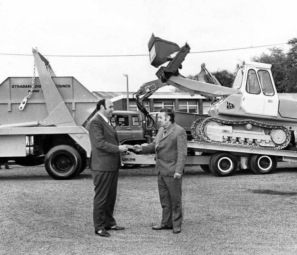 Jack Kernohan hands over a skip lorry and digger trailer in 1967