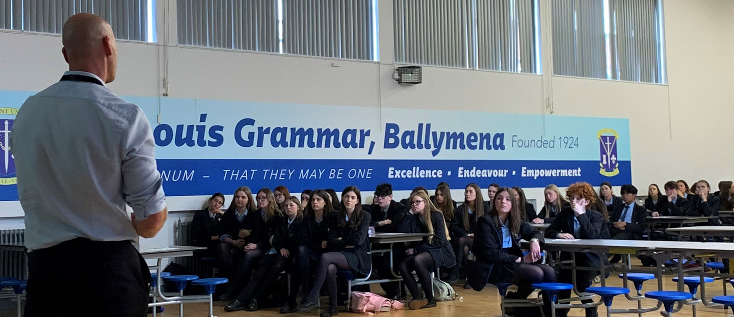 school assembly hall with pupils and speaker