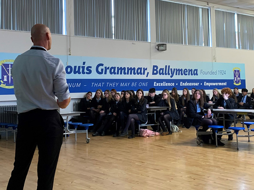 school assembly hall with pupils and speaker