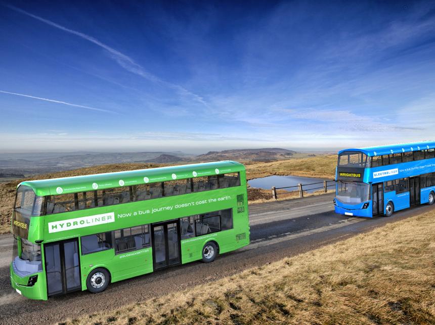 green and blue double decker buses driving along a country road