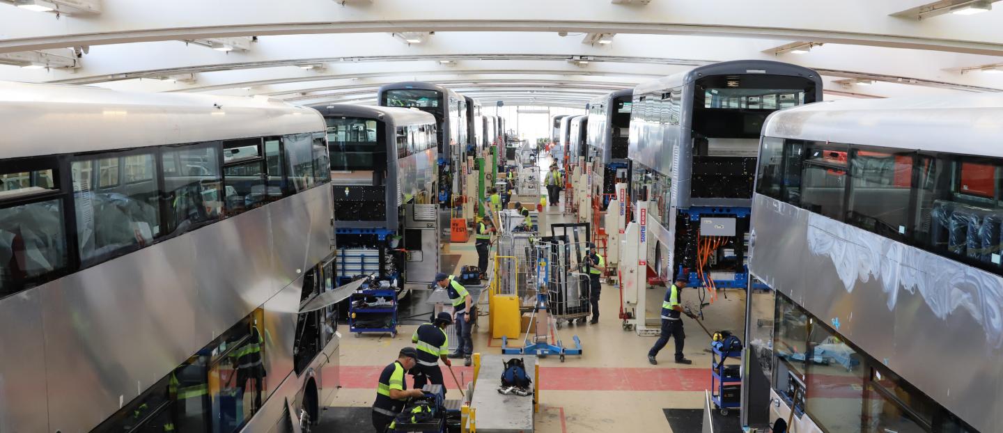 photograph of Wrightbus main production line showing bus builds and employees