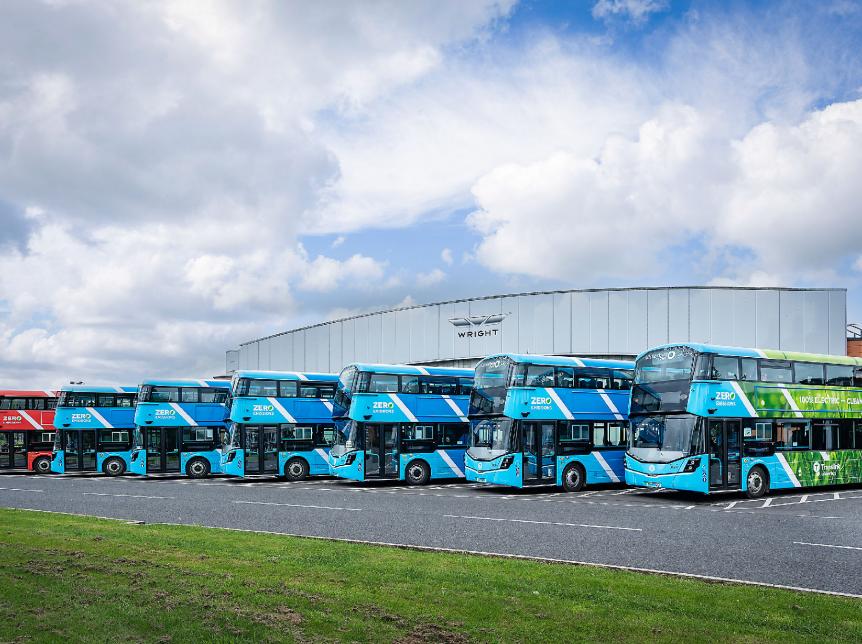 a line up of double deck battery electric buses outside the Wrightbus factory