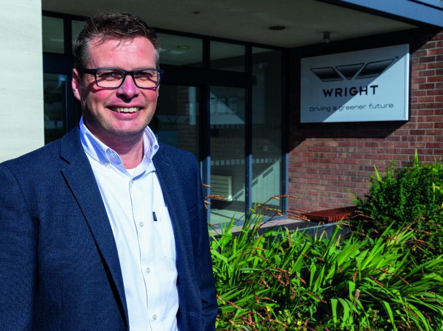 James Hamill smiling in front of the wrightbus main entrance