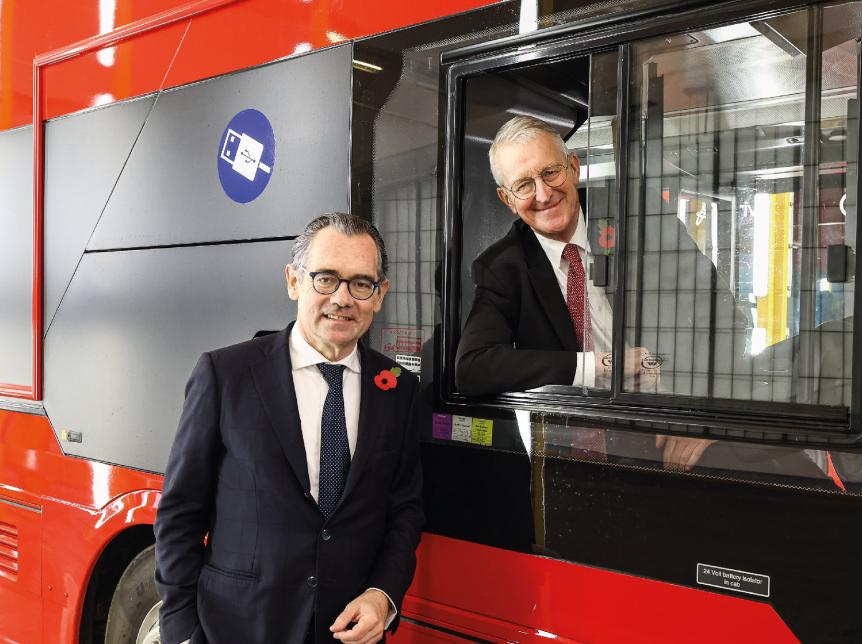 Secretary of State Hilary Benn and Jean-Marc Gales, Wrightbus CEO, pictured with a red double deck bus