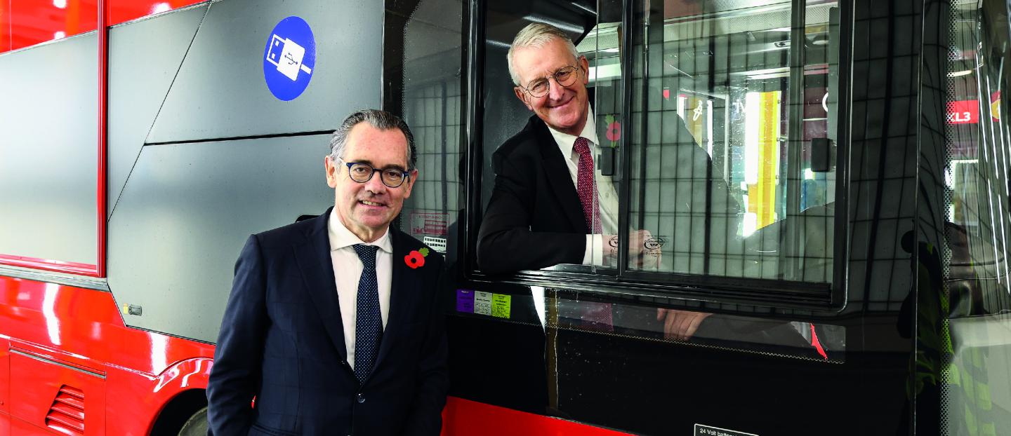 Secretary of State Hilary Benn and Jean-Marc Gales, Wrightbus CEO, pictured with a red double deck bus