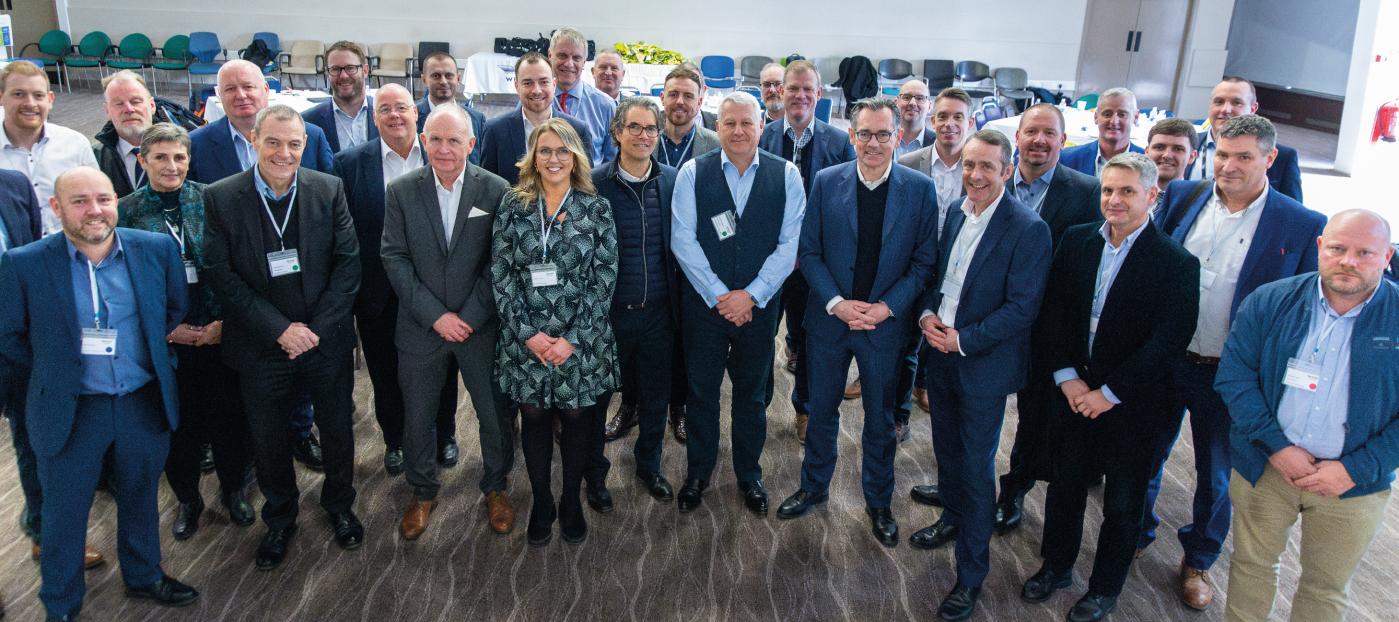 group of suppliers and Wrightbus team at the recent Supplier Event. The group are all standing in rows smiling at the camera