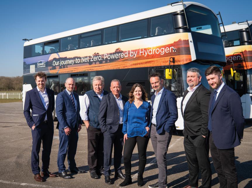 Sizewell C team line up in front of a double deck hydrogen bus