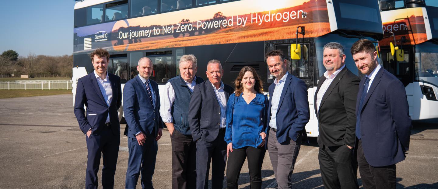 Sizewell C team line up in front of a double deck hydrogen bus