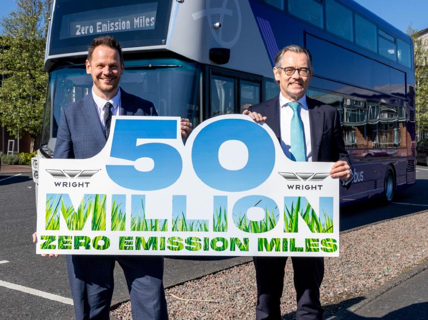 Simon Lightwood MP and Jean-Marc Gales Wrightbus CEO holding a sign that says 50million zero emission miles