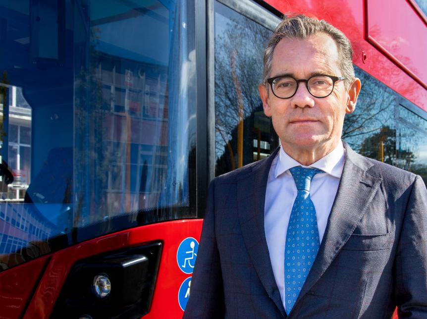 Jean-Marc Gales, Wrightbus CEO standing in front of of a red bus