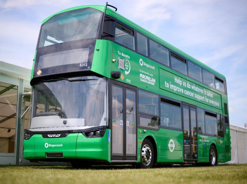 a green double deck bus with livery messaging and branding for Macmillan Cancer Support
