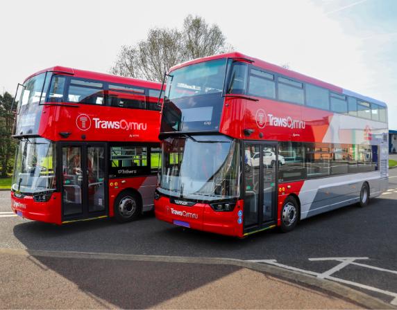 two Wrightbus double deck buses with TrawsCymru liveries. the buses are parked side by side