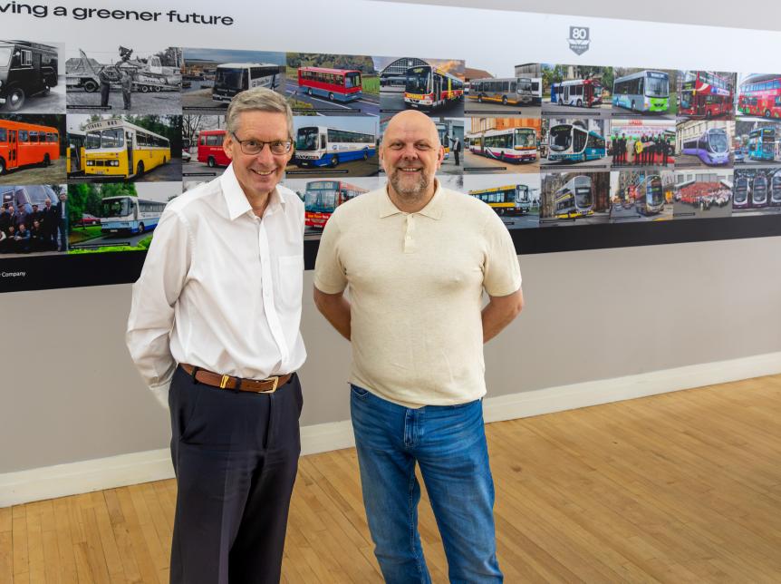 Christian Reynolds and Paul Savage with Wrightbus 80th wall photo montage